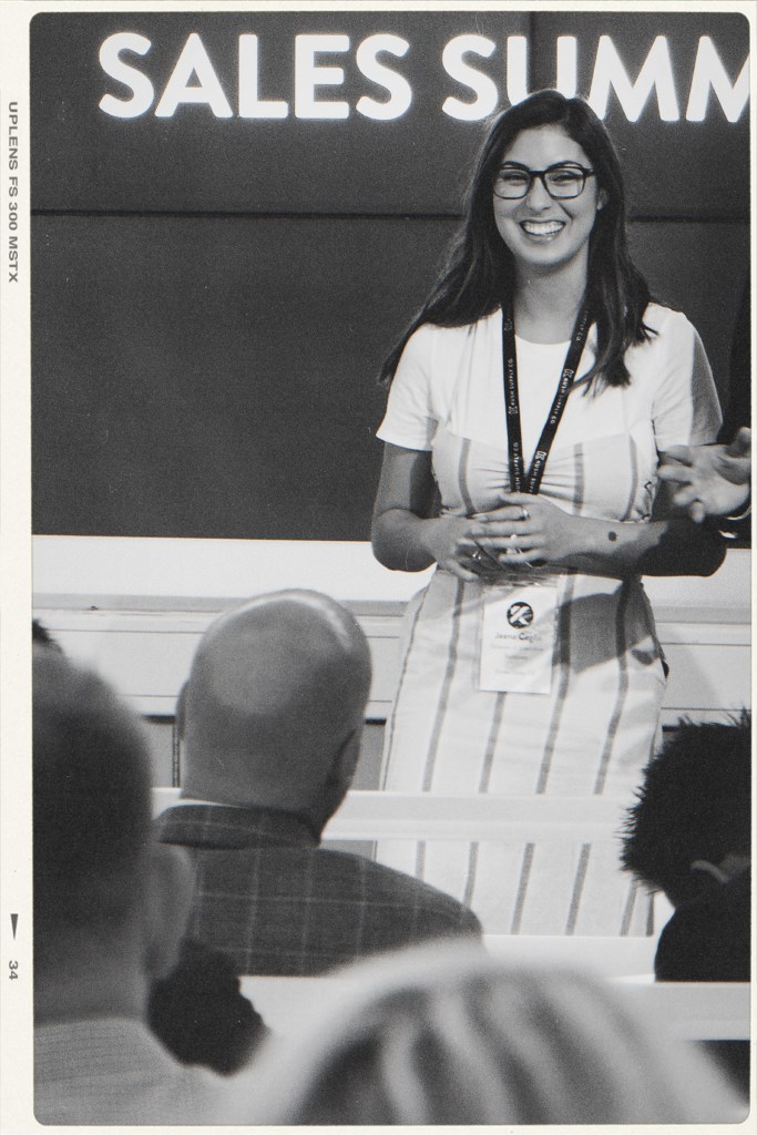 jeana ceglia home page picture presenting in front of sales